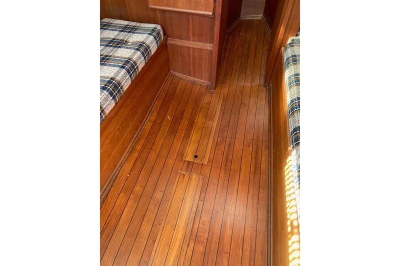Slide: The Image of Interior of 1982 Sabre 30 sailboat with wooden flooring and plaid seating. - 20