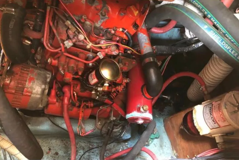 Slide: The Image of Engine compartment of a 1982 Sabre 30 sailboat, featuring hoses and wiring. - 22