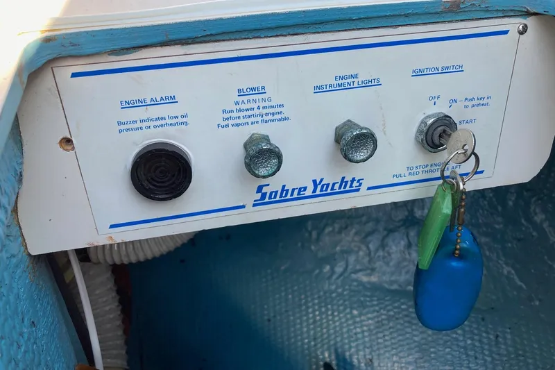 Slide: The Image of Control panel of a 1982 Sabre 30 yacht with ignition switch and engine alarm. - 23