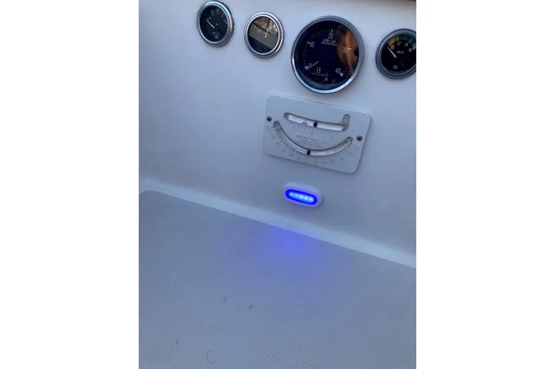 Slide: The Image of Control panel of a 1982 Sabre 30 boat with gauges and blue LED light. - 24