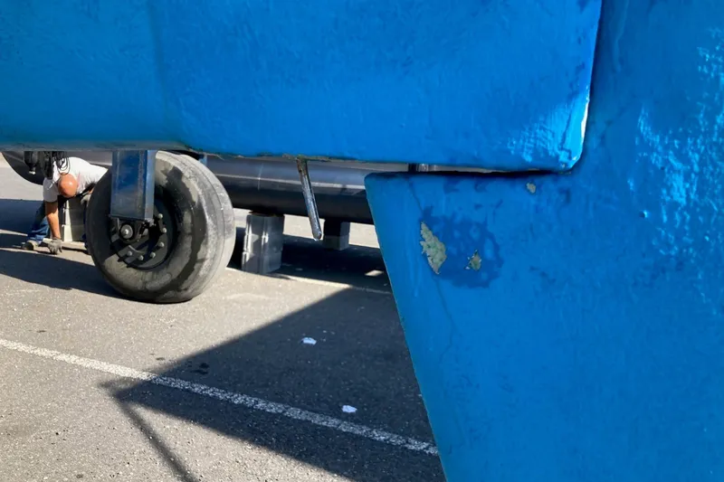 Slide: The Image of Close-up of a blue Sabre 30 sailboat keel, 1982 model, with visible wear. - 26