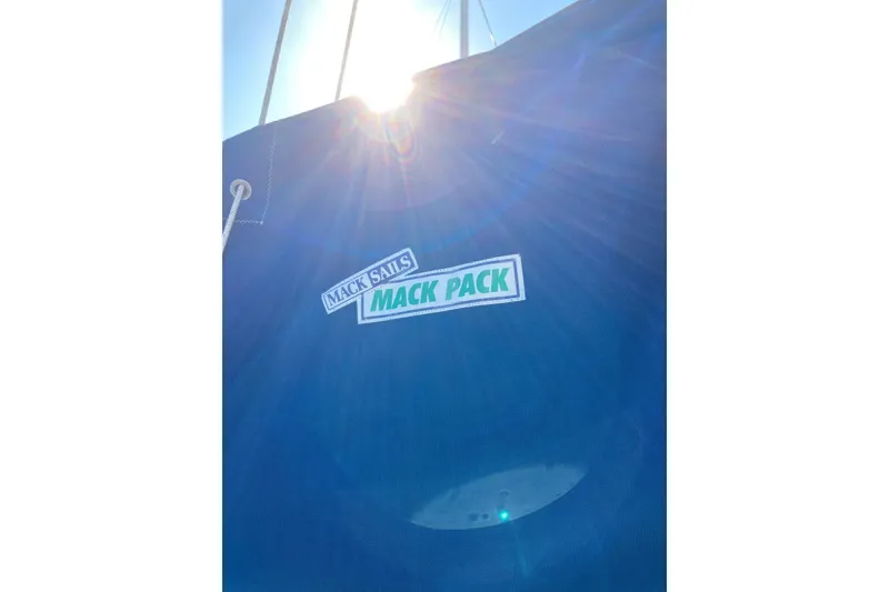 Slide: The Image of Blue sail cover with "Mack Sails Mack Pack" logo, sunlight shining through. Sabre 30, 1982. - 27