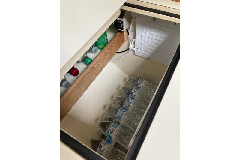 Slide: The Image of Built-in cooler with drinks and water bottles in a 1982 Sabre 30 sailboat. - 28