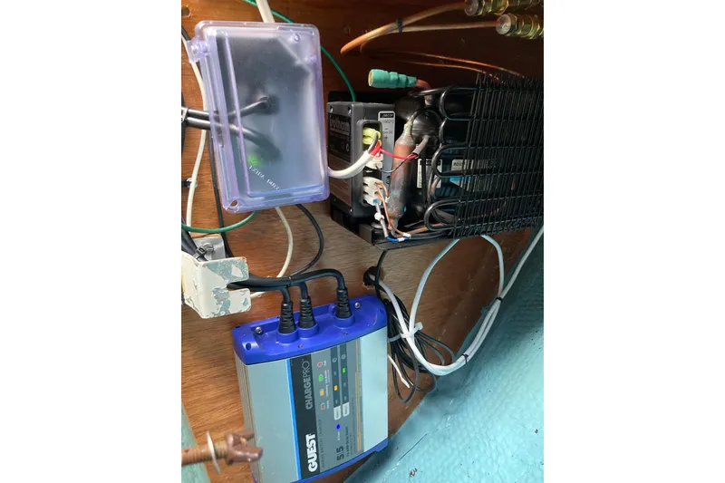 Slide: The Image of Electrical setup inside a 1982 Sabre 30 boat, featuring a Quest ChargePro device. - 29