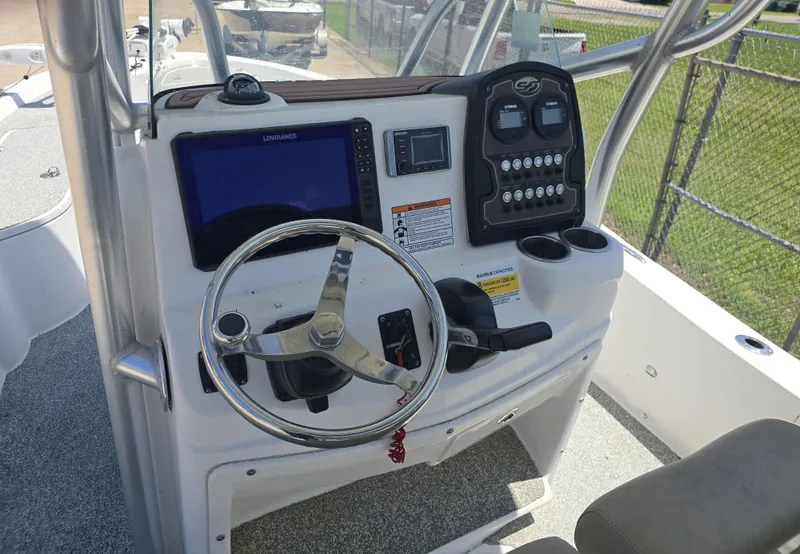 Slide: The Image of 2017 Sea Fox 240 Viper boat console with steering wheel and navigation controls. - 11