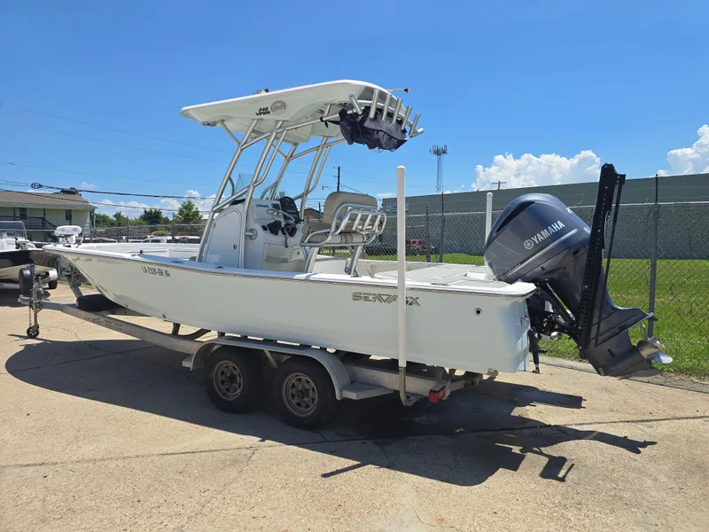 Slide: The Image of 2017 Sea Fox 240 Viper boat on trailer with Yamaha outboard motor, parked outdoors. - 2