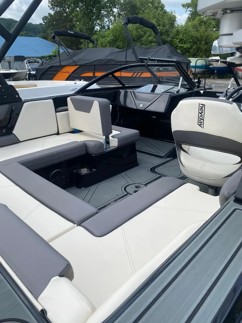 Slide: The Image of 2025 Heyday WTSurf boat interior with white and gray seating, showcasing modern design. - 12