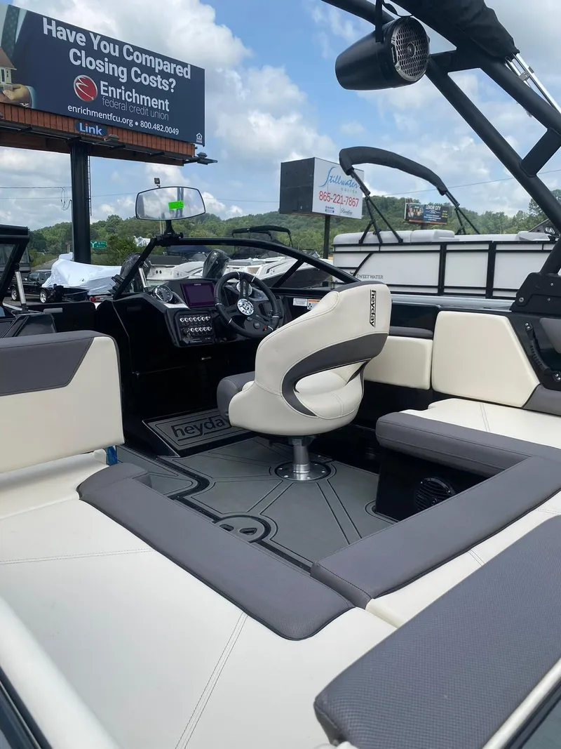 Slide: The Image of 2025 Heyday WTSurf boat interior with modern seating and control panel. - 13