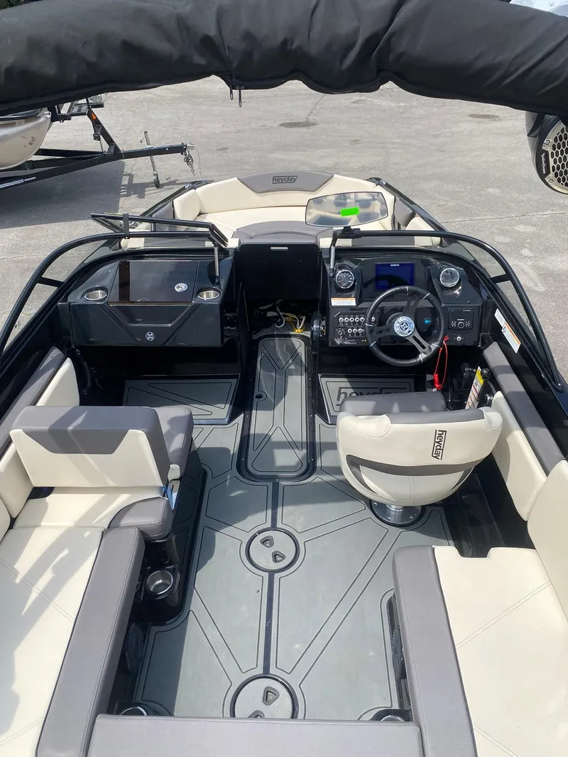 Slide: The Image of 2025 Heyday WTSurf boat interior with modern dashboard and seating arrangement. - 15