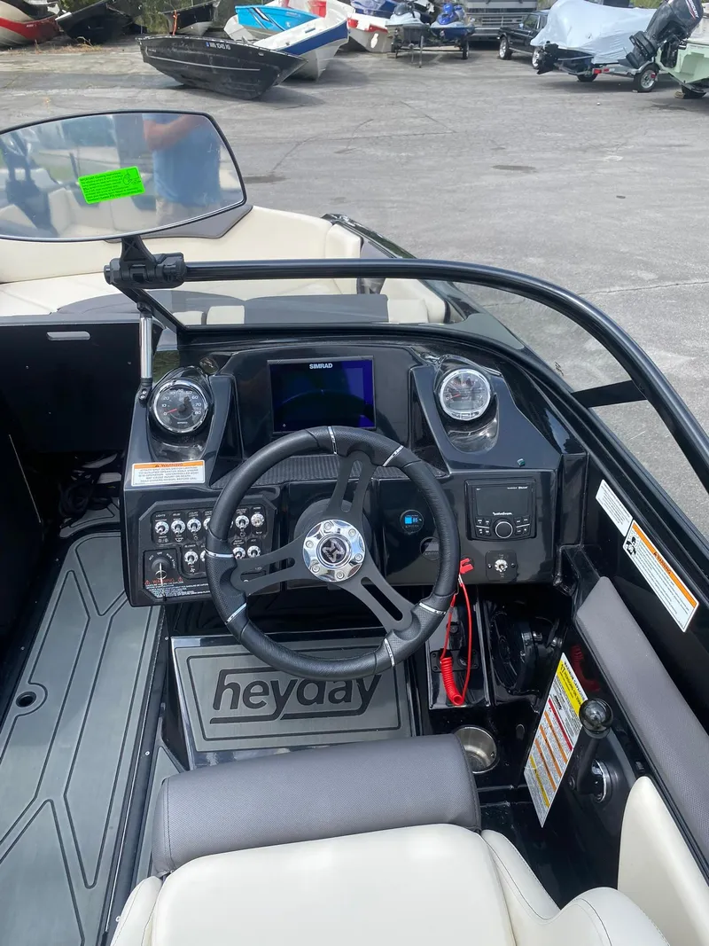 Slide: The Image of 2025 Heyday WTSurf boat dashboard with steering wheel and control panel. - 16