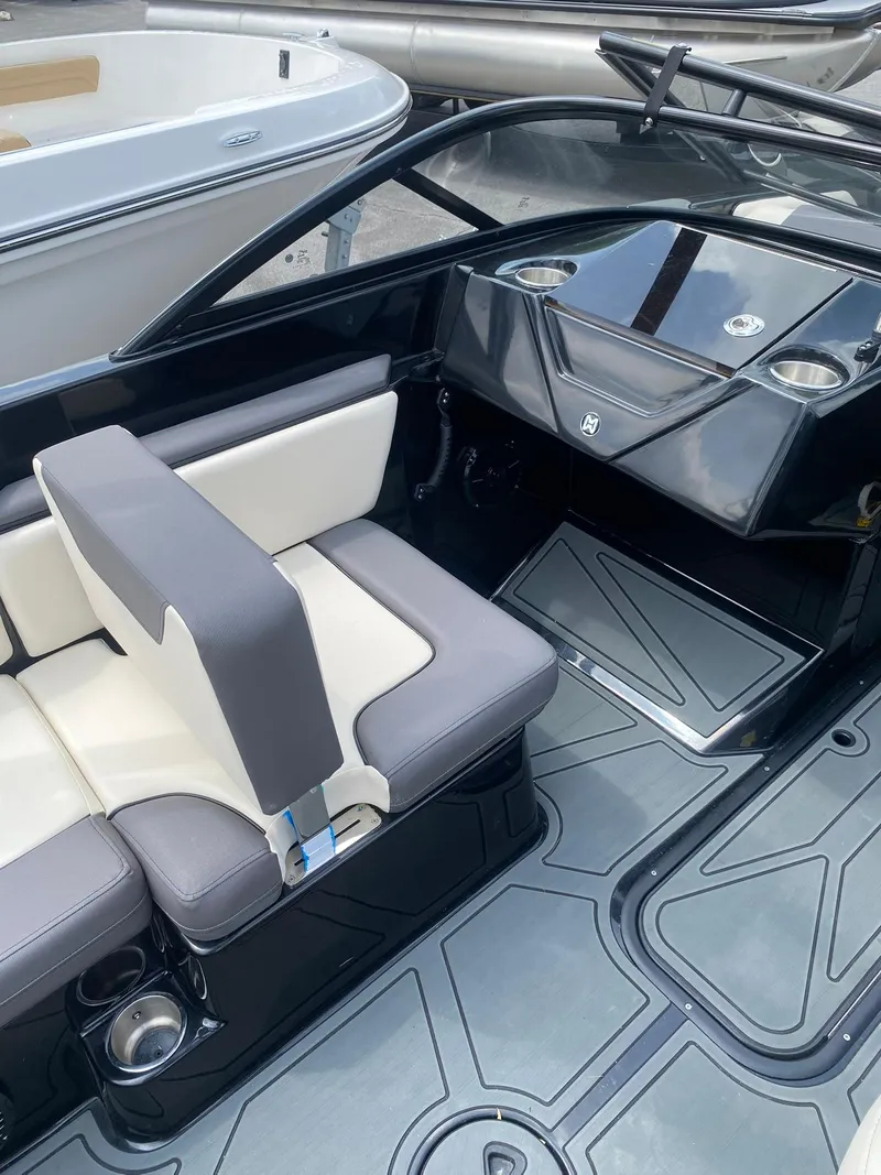 Slide: The Image of Interior of 2025 Heyday WTSurf boat with sleek seating and modern dashboard design. - 17