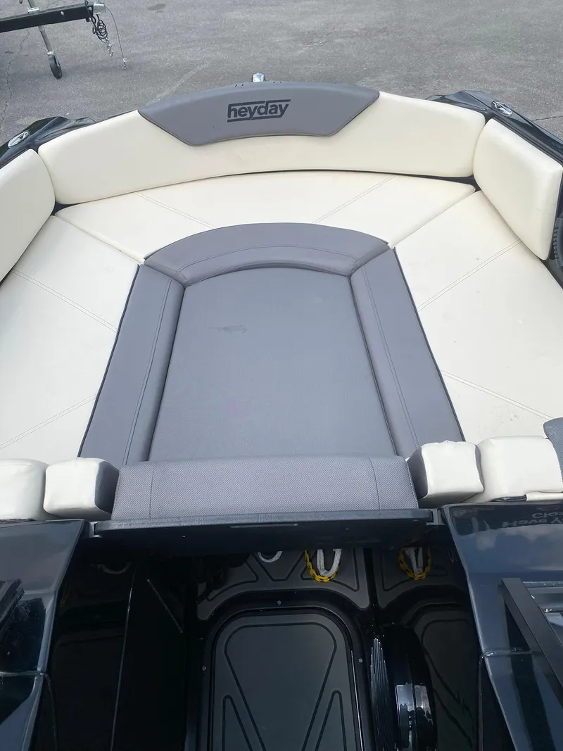 Slide: The Image of 2025 Heyday WTSurf boat interior with beige and gray seating. - 18