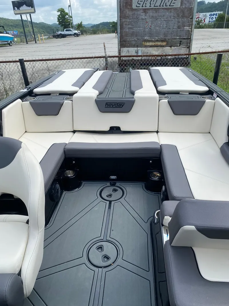 Slide: The Image of 2025 Heyday WTSurf boat interior with white and gray seating, spacious layout, and modern design. - 19