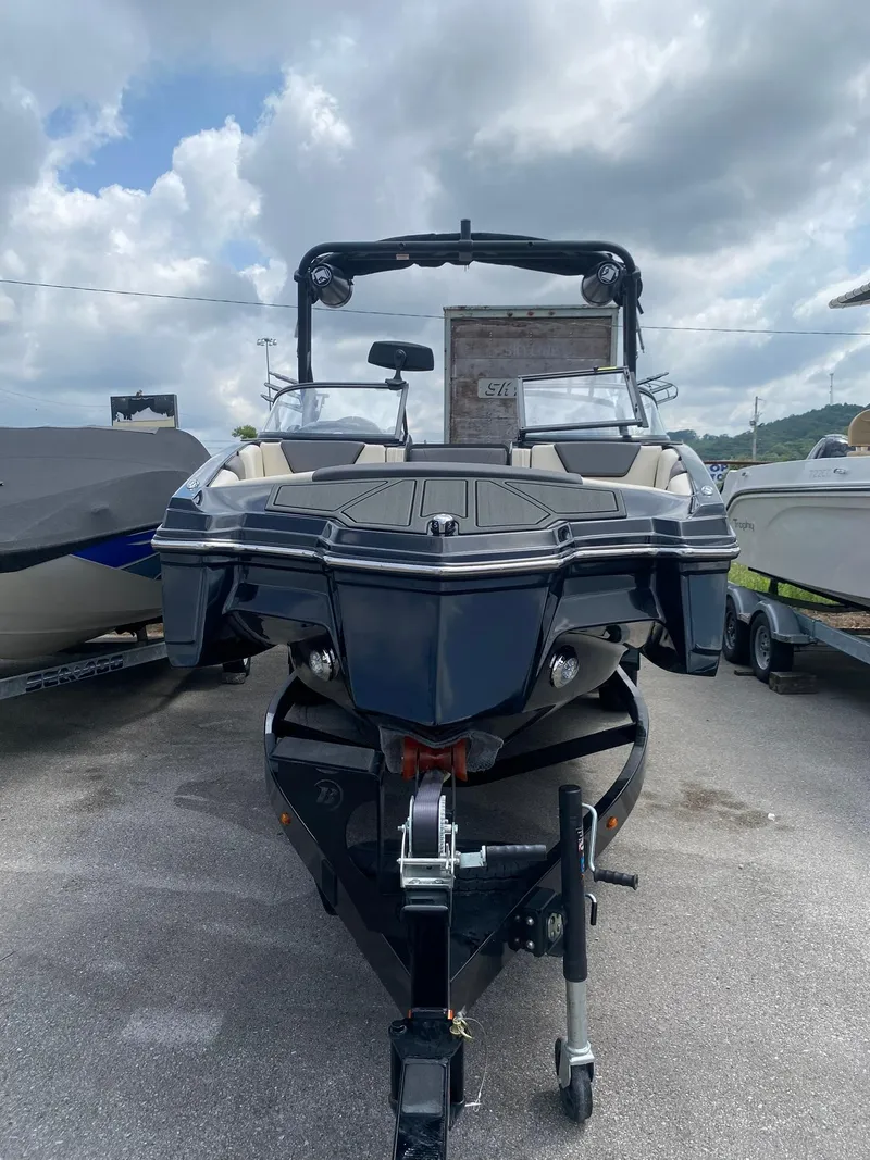 Slide: The Image of 2025 Heyday WTSurf boat on trailer under cloudy sky. - 3