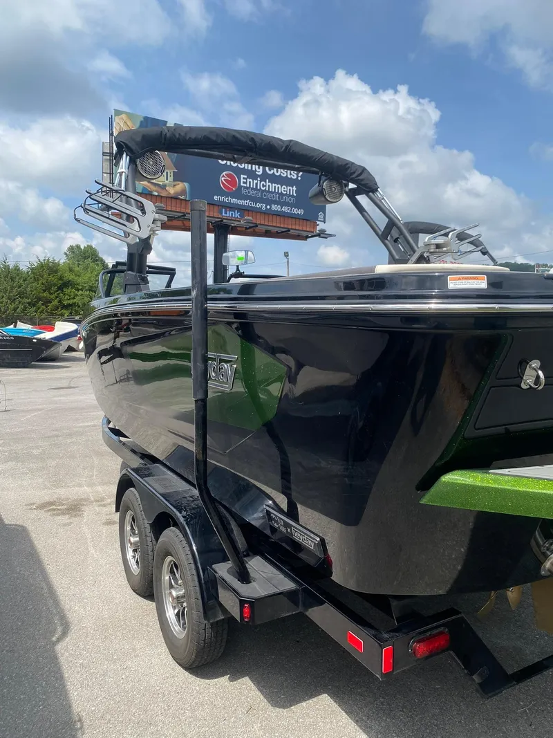 Slide: The Image of 2025 Heyday WTSurf boat on trailer, parked outdoors under a cloudy sky. - 7