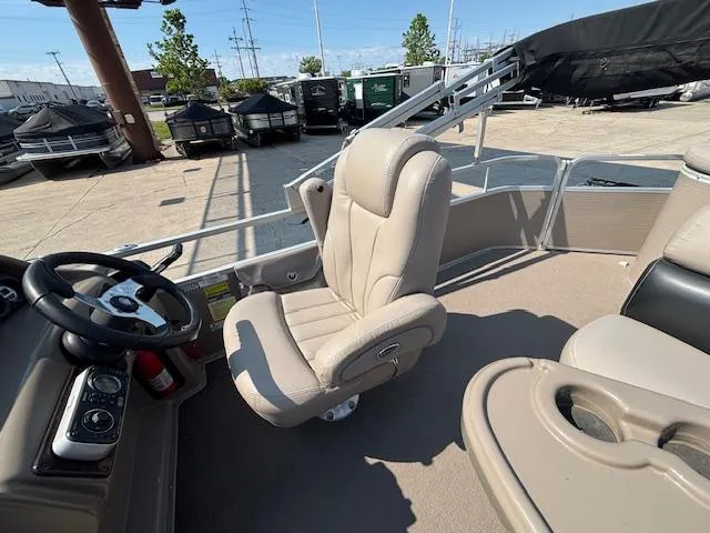 Slide: The Image of Interior of 2009 Premier 225 Grand Majestic boat with beige seating and steering wheel. - 14