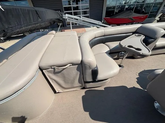 Slide: The Image of 2009 Premier 225 Grand Majestic pontoon boat with beige seating and cup holders. - 16
