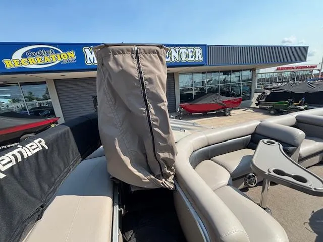 Slide: The Image of 2009 Premier 225 Grand Majestic boat at dealership, featuring covered seating and modern design. - 17