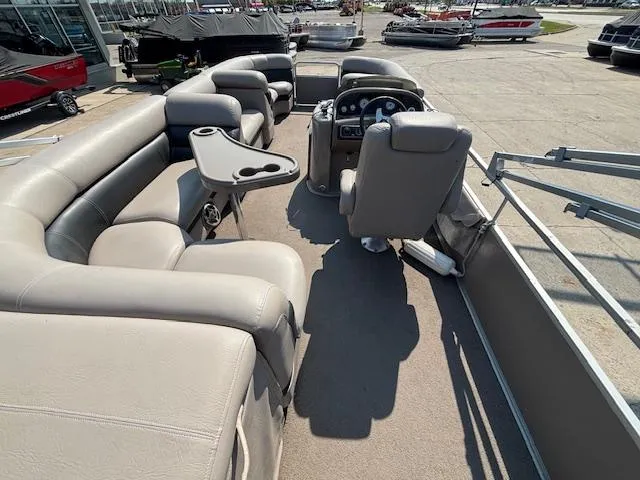 Slide: The Image of 2009 Premier 225 Grand Majestic pontoon boat interior with plush seating and steering console. - 18