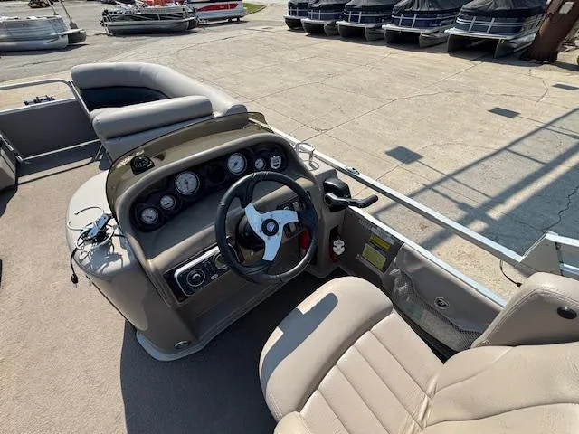 Slide: The Image of 2009 Premier 225 Grand Majestic boat dashboard with steering wheel and gauges. - 20
