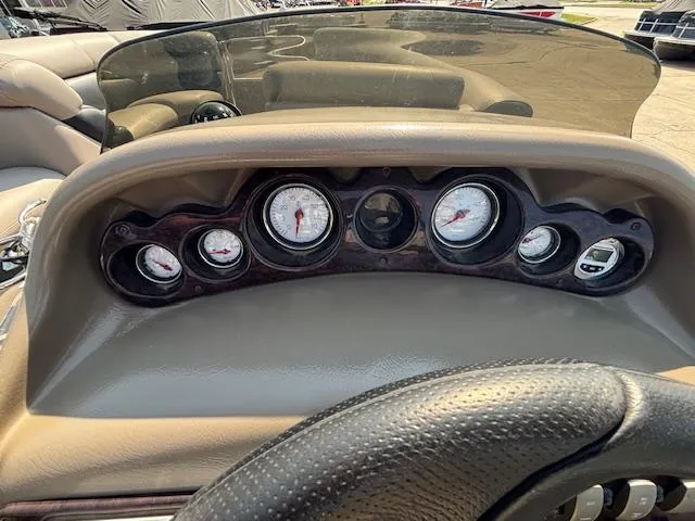 Slide: The Image of Dashboard of 2009 Premier 225 Grand Majestic boat with gauges and steering wheel. - 22