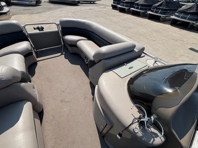 Slide: The Image of 2009 Premier 225 Grand Majestic pontoon boat interior with plush seating and steering console. - 24