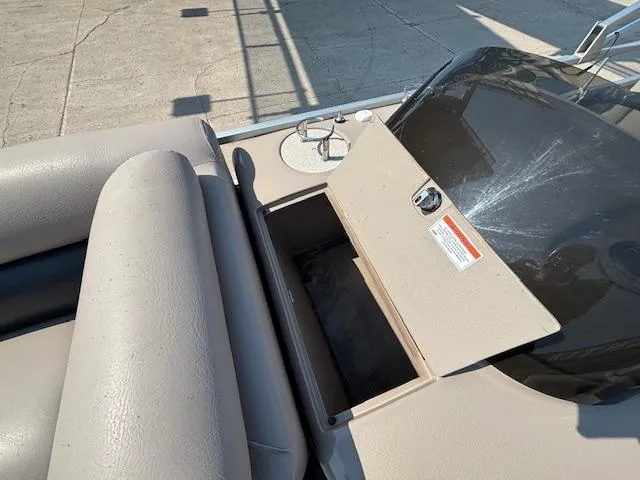 Slide: The Image of 2009 Premier 225 Grand Majestic boat interior with open storage compartment and seating. - 26