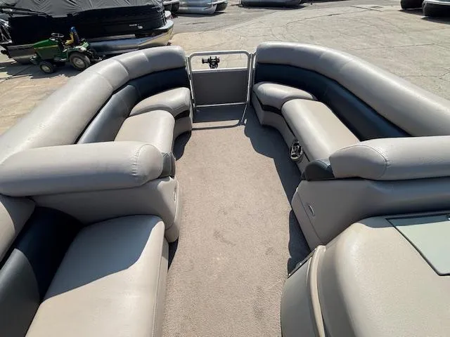 Slide: The Image of 2009 Premier 225 Grand Majestic pontoon boat interior with gray seating and open deck. - 28