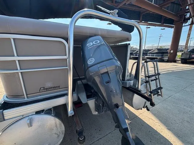 Slide: The Image of 2009 Premier 225 Grand Majestic boat with 90 HP outboard motor, docked outdoors. - 3