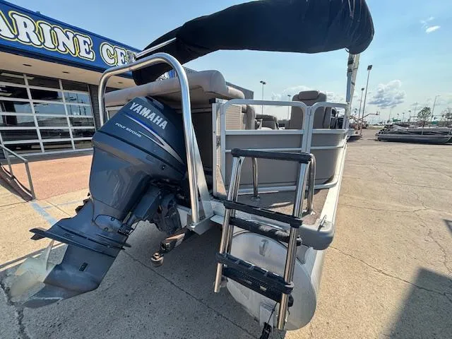 Slide: The Image of 2009 Premier 225 Grand Majestic pontoon boat with Yamaha outboard motor at a marine center. - 4