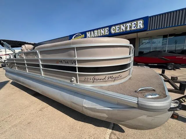 Slide: The Image of 2009 Premier 225 Grand Majestic pontoon boat parked at a marine center. - 6
