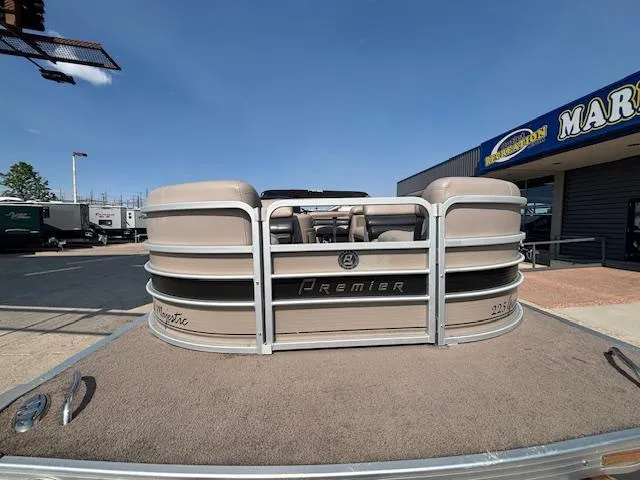 Slide: The Image of 2009 Premier 225 Grand Majestic pontoon boat at a dealership under clear blue skies. - 7