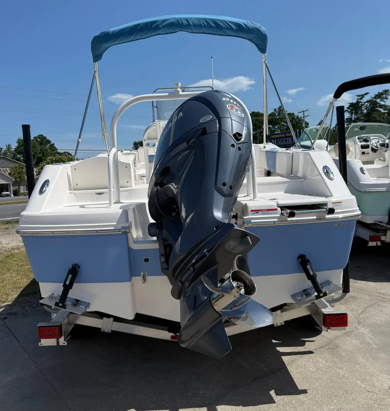 Slide: The Image of 2025 Robalo R200 Center Console boat with outboard motor, parked on a sunny day. - 3