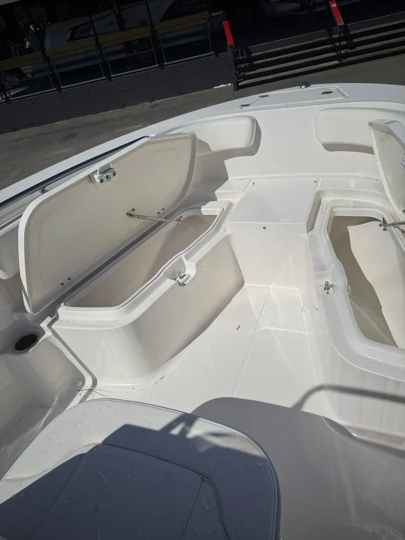 Slide: The Image of 2025 Robalo R200 Center Console boat with open storage compartments. - 6