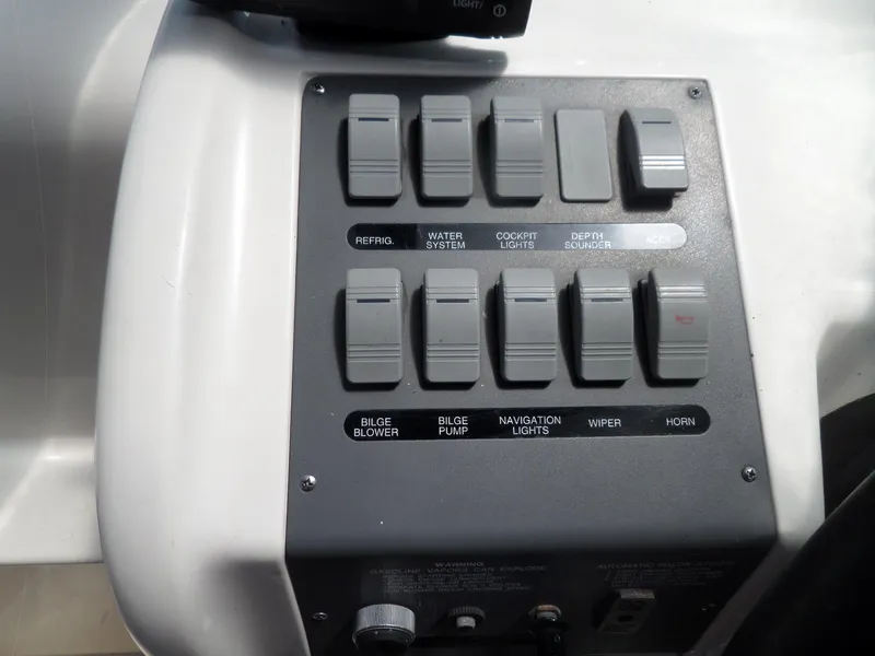 Slide: The Image of Control panel of a 1995 Sea Ray 250 Sundancer boat with labeled switches. - 18