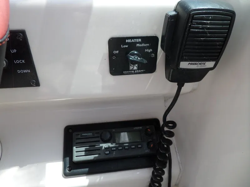 Slide: The Image of Control panel of a 1995 Sea Ray 250 Sundancer boat with radio and heater settings. - 19