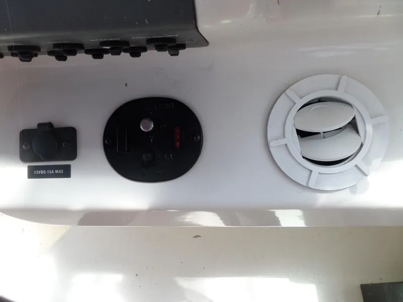 Slide: The Image of Control panel of a 1995 Sea Ray 250 Sundancer boat with 12VDC outlet and vent. - 21