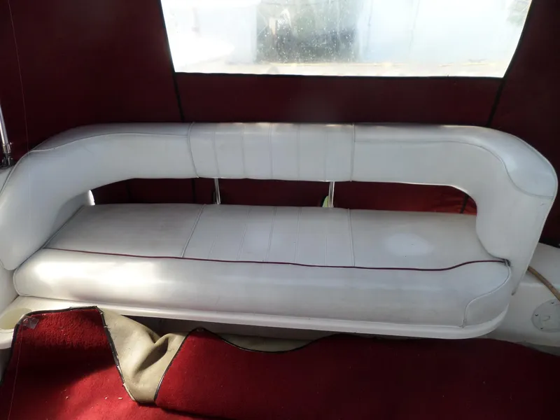 Slide: The Image of White leather seating on 1995 Sea Ray 250 Sundancer boat with red interior accents. - 23