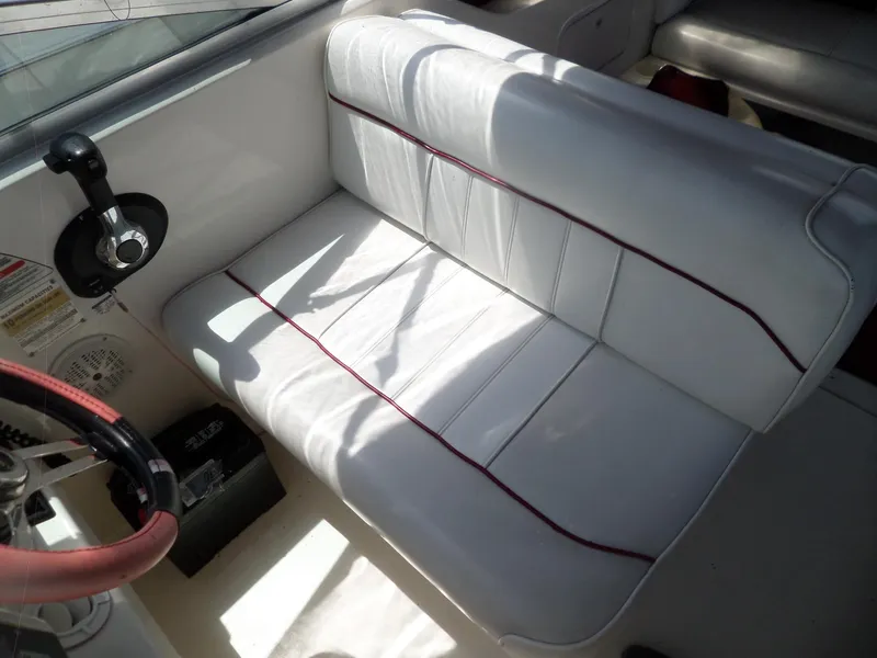 Slide: The Image of White leather seating in a 1995 Sea Ray 250 Sundancer boat interior. - 25