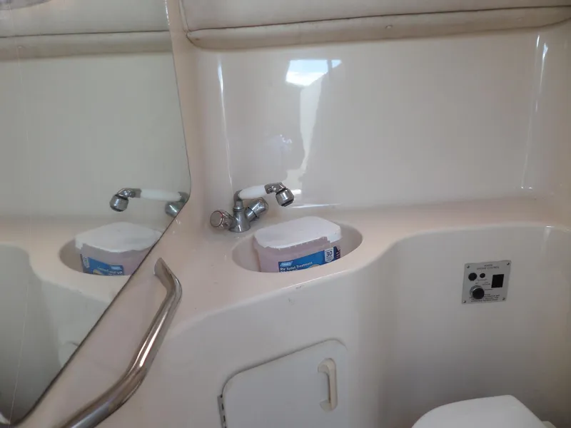 Slide: The Image of 1995 Sea Ray 250 Sundancer bathroom with sink, mirror, and storage compartment. - 31