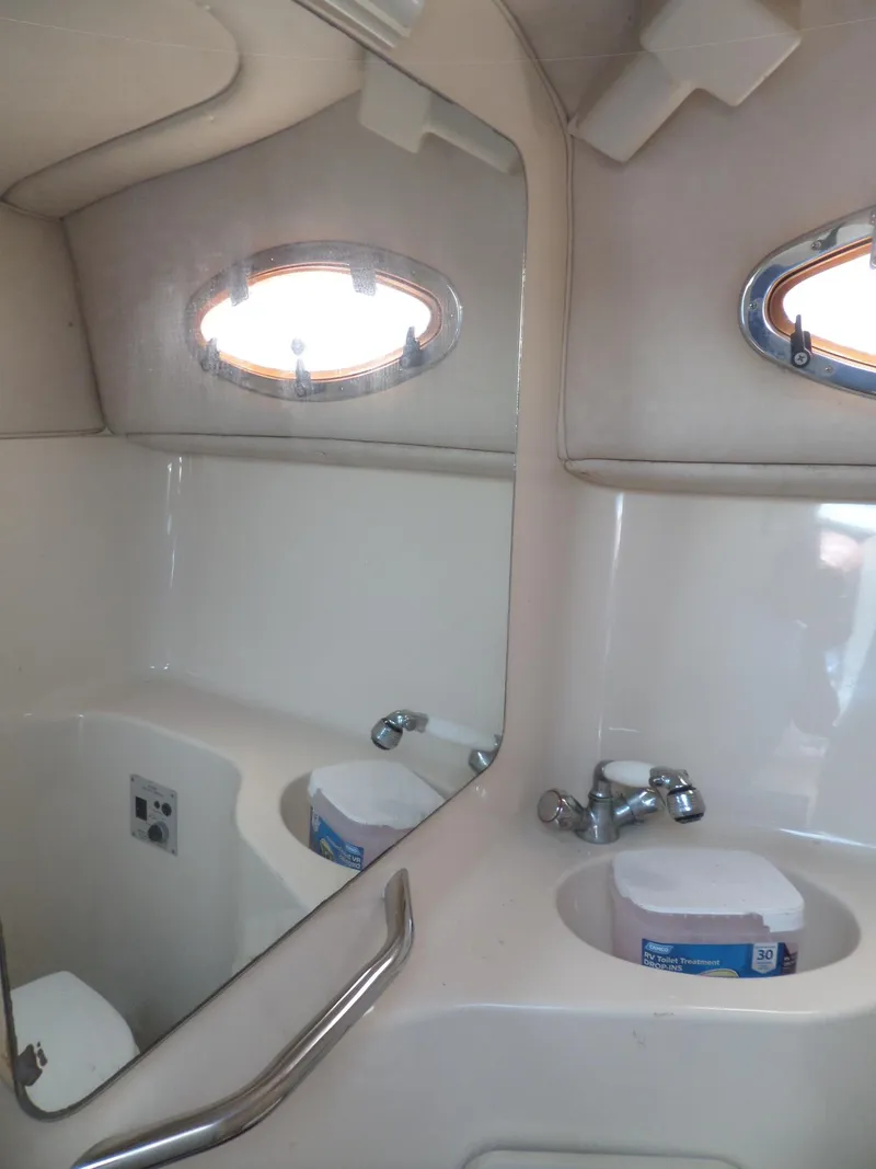 Slide: The Image of Interior of 1995 Sea Ray 250 Sundancer boat bathroom with sink and mirror. - 33