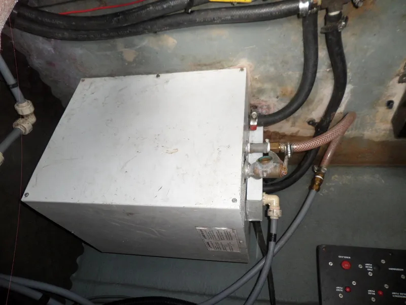 Slide: The Image of 1995 Sea Ray 250 Sundancer engine compartment with wiring and components. - 41