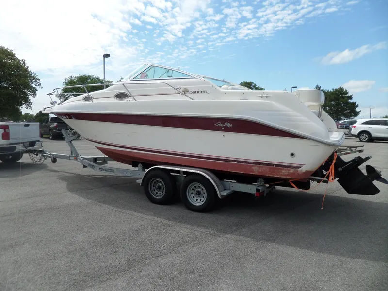 Slide: The Image of 1995 Sea Ray 250 Sundancer boat on trailer in parking lot under blue sky. - 5