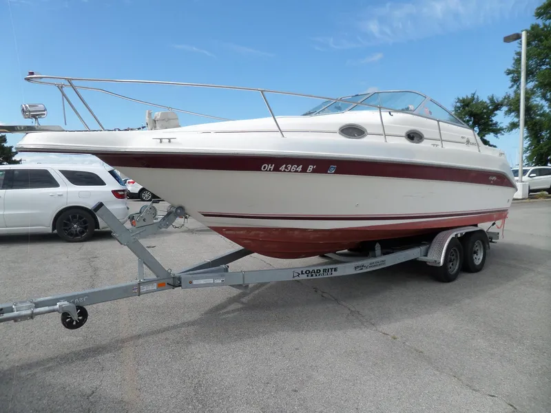 Slide: The Image of 1995 Sea Ray 250 Sundancer boat on trailer in parking lot. - 7