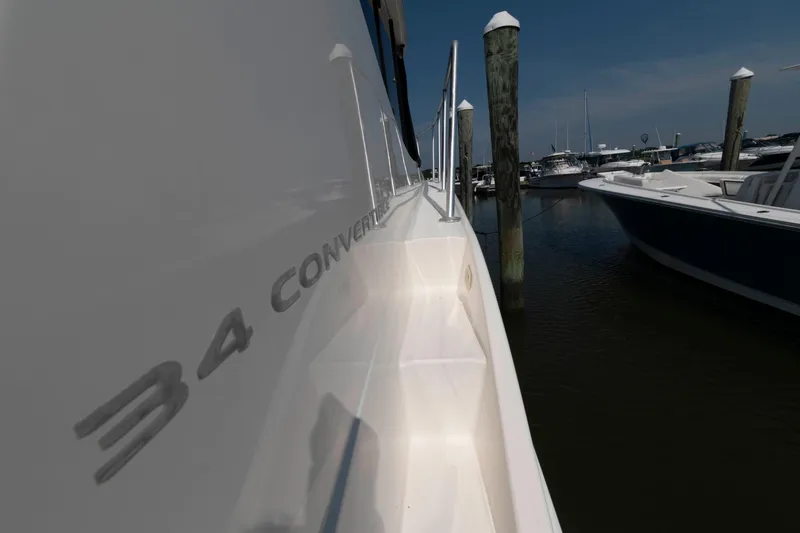 Slide: The Image of 2004 Silverton 34 Convertible yacht docked at marina, side view. - 12