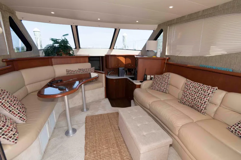 Slide: The Image of Luxurious interior of 2004 Silverton 34 Convertible yacht with plush seating and elegant decor. - 13