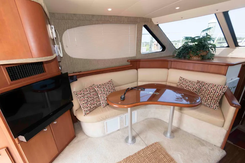 Slide: The Image of Interior of 2004 Silverton 34 Convertible yacht with cozy seating and modern amenities. - 15