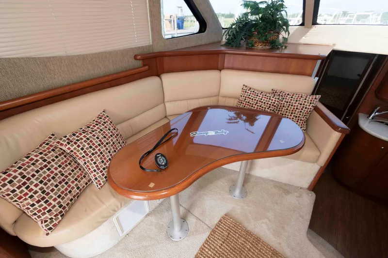 Slide: The Image of Luxurious interior of 2004 Silverton 34 Convertible yacht with plush seating and elegant table. - 16