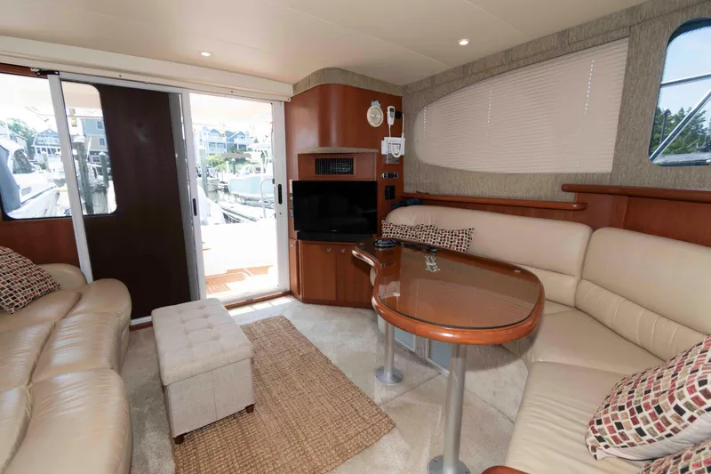 Slide: The Image of Interior of 2004 Silverton 34 Convertible yacht with plush seating and entertainment area. - 17