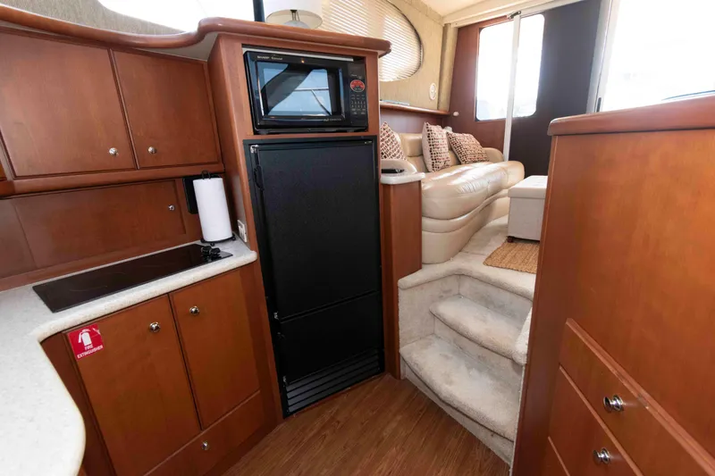 Slide: The Image of Interior of 2004 Silverton 34 Convertible yacht with kitchen and seating area. - 19